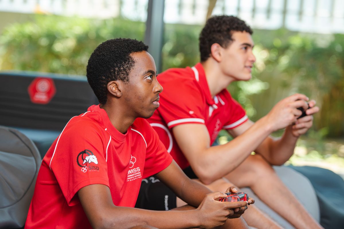 2 Male Students Playing With Controllers At The Swiss International Scientific School Dubai
