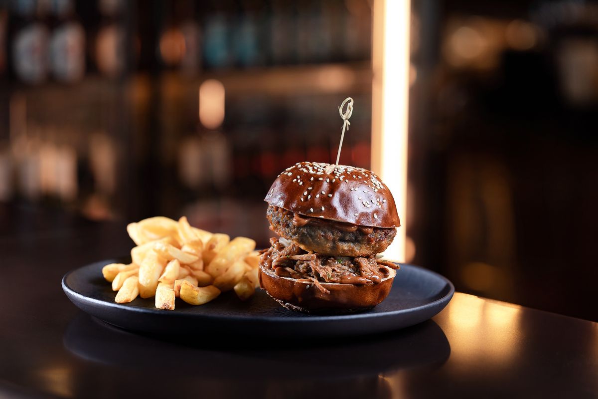 A plate of delicious burger with a side of fries at The Copperhead Pub Marriott Hotels best places to watch Euro 2024 in Dubai