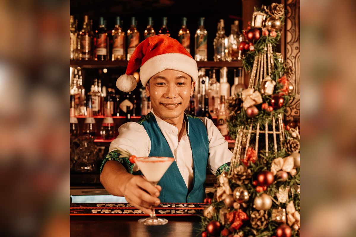 A Bartender Serving A Drink For Christmas In July At Trader Vic'S Dubai