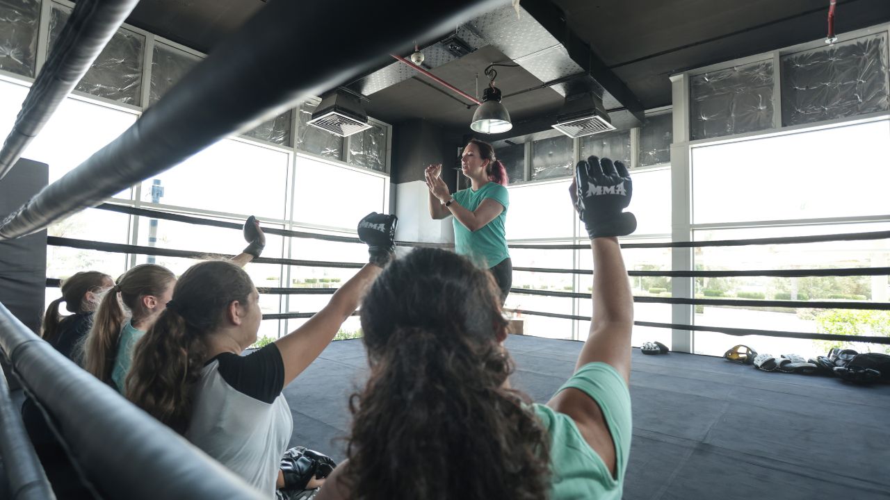 teenage girls taking self defence class and sparring