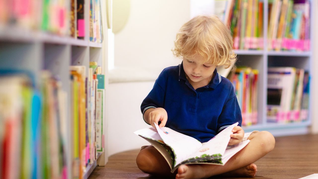 Child reading a book in school library