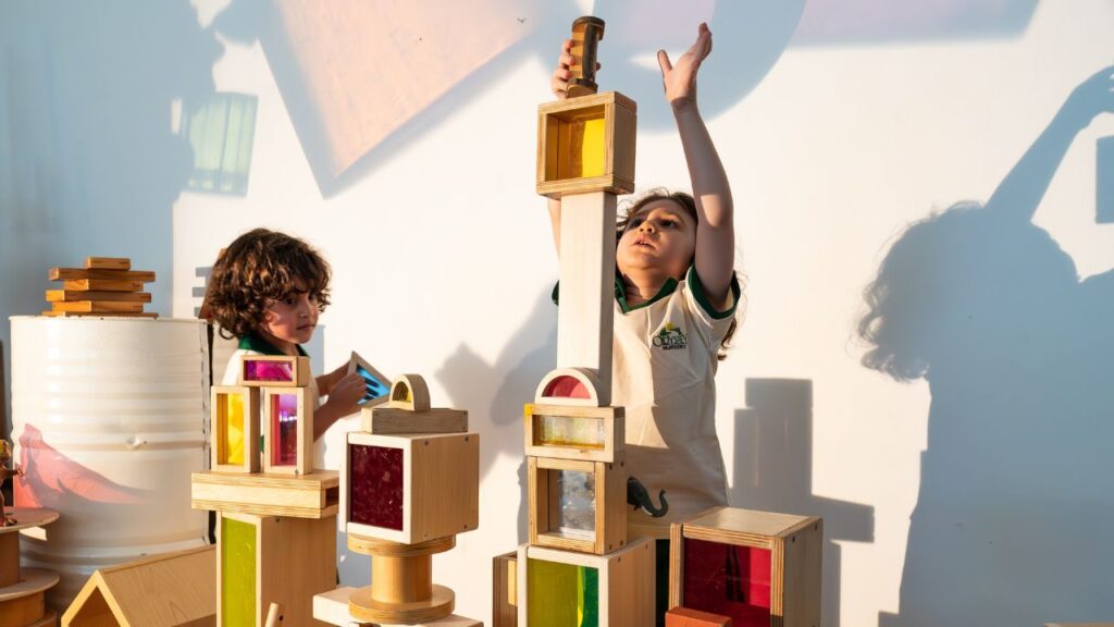 Children playing with wooden blocks at Odyssey Nursery.