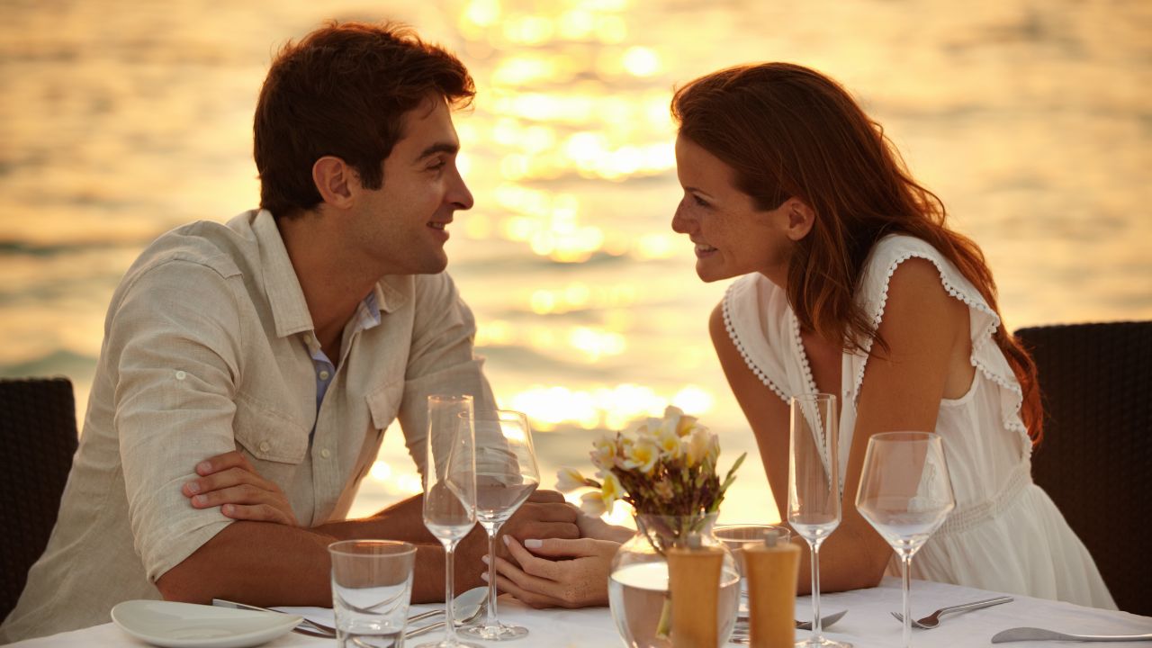 Couple on a romantic dinner by the beach