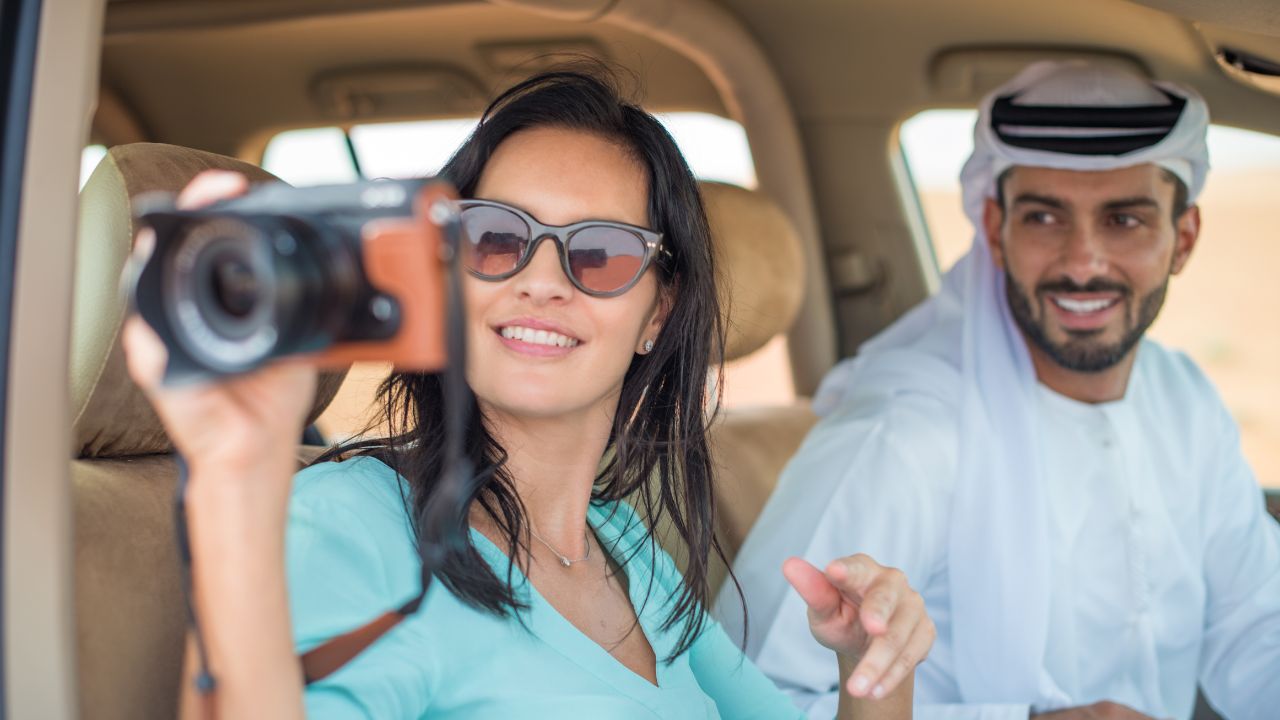 Woman taking photo while touring desert