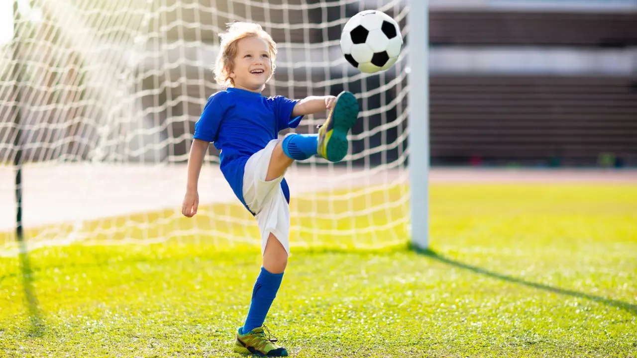 happy child playing football on break