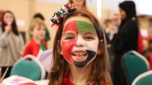student with painted face of uae flag