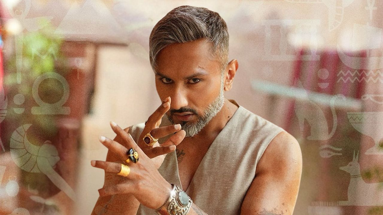 Stylish man with silver hair and beard, posing confidently indoors.