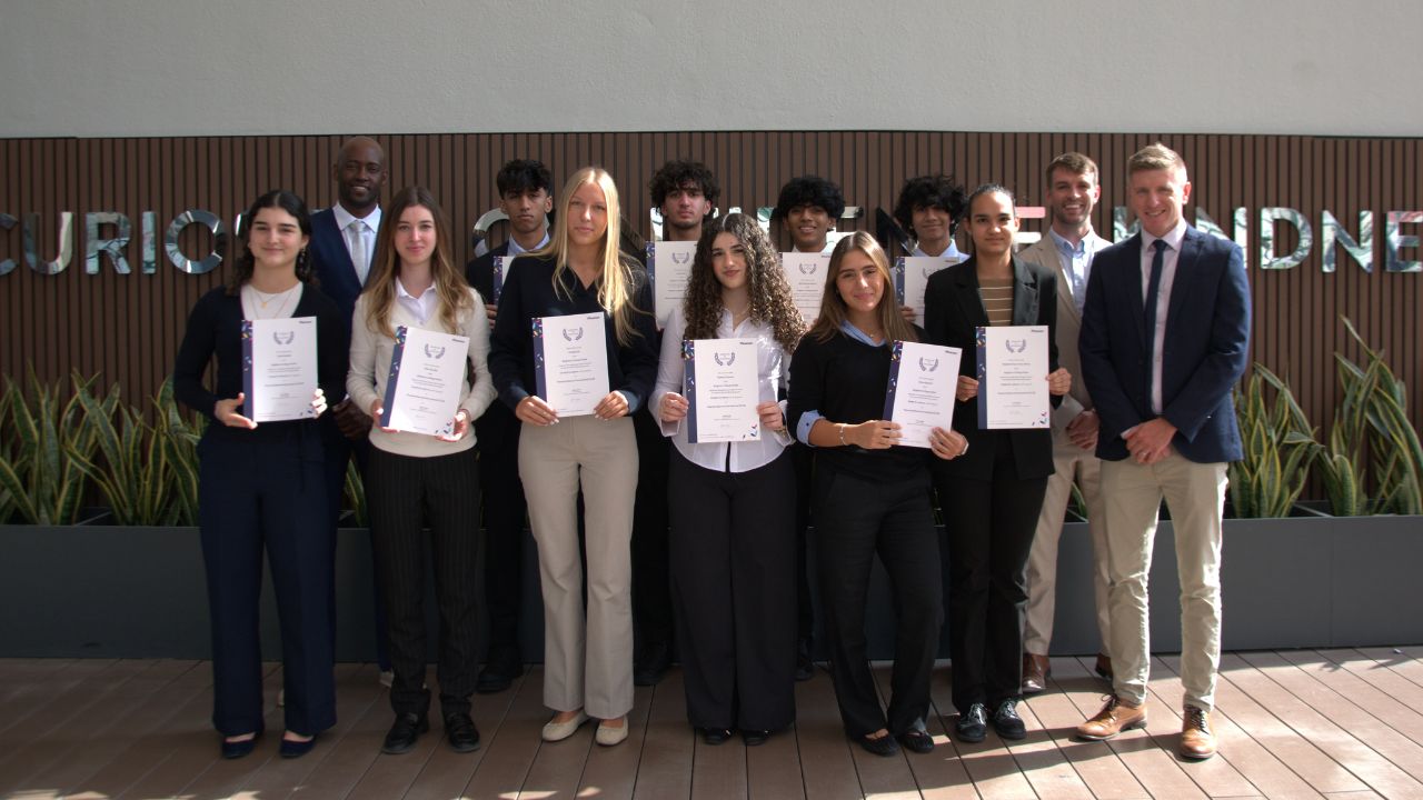 Dubai Pupils Achieve Top GCSE Results Group of students holding certificates after excelling in Pearson Edexcel GCSEs in Dubai.