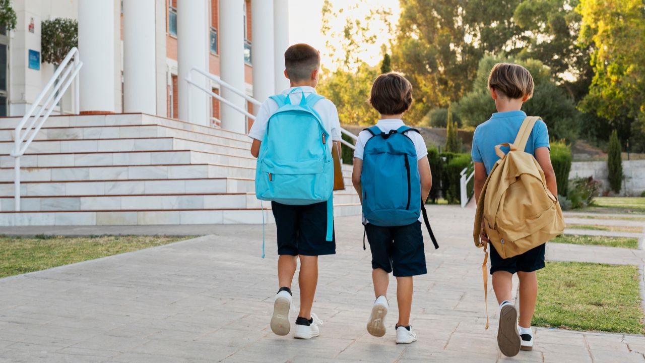 students (2) children walking together to school