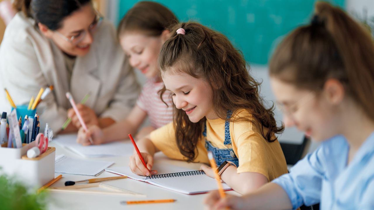 Yalla Dubai Life Children studying in classroom with teacher.