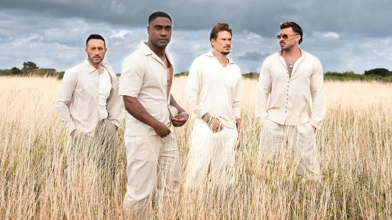 Blue British boyband in a wheat field, promoting Dubai concert. Blue British boyband performing outdoors in a wheat field, promoting their upcoming Dubai concert.