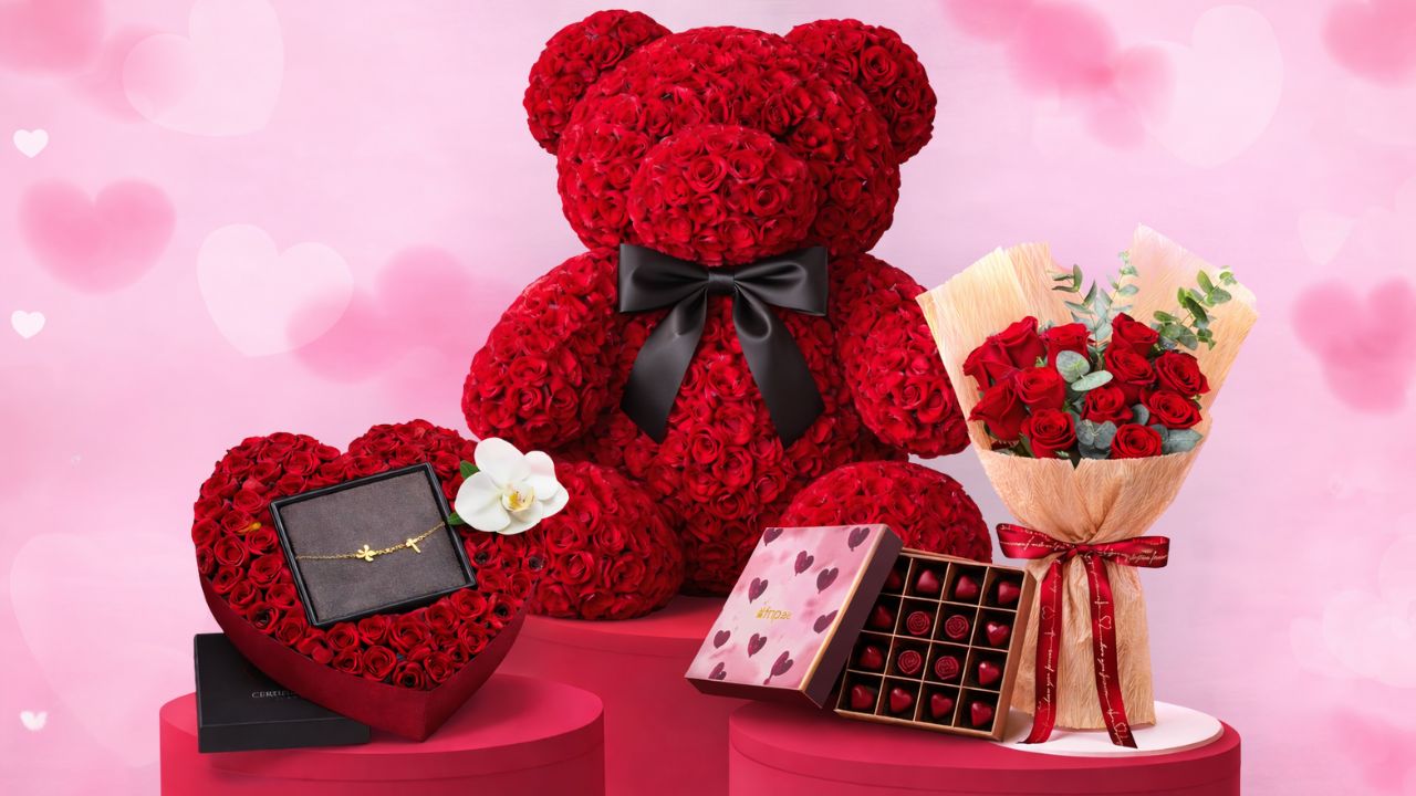 Yalla Dubai Life: Valentine's Floral Bear and Gifts Red floral teddy bear with black bow, heart-shaped box, and bouquet of roses.