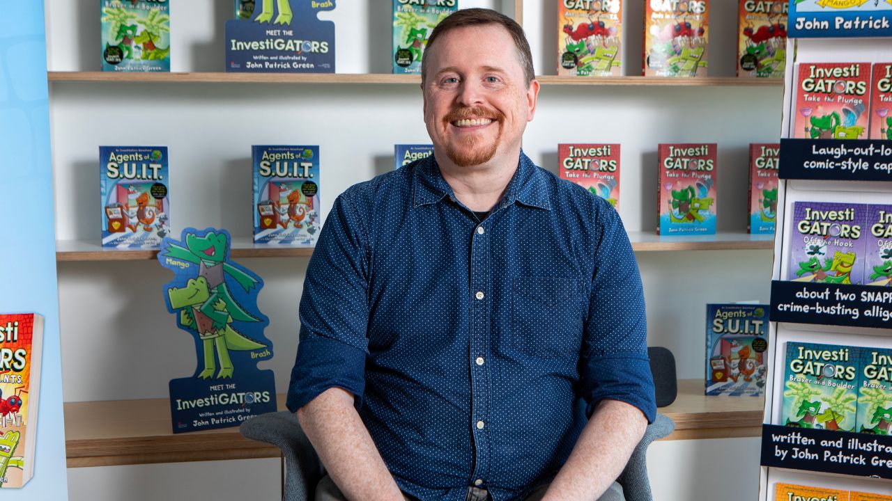 Yalla Dubai Life - InvestiGators Author Event Author John Patrick Green with his graphic novels at Yalla Dubai.