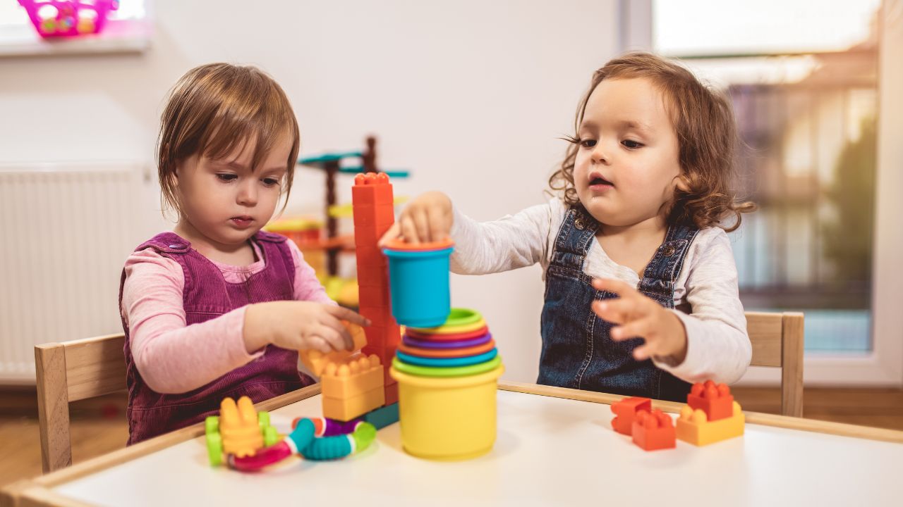 Nursery Playtime in Dubai Two young children playing with colourful toys at a Dubai nursery.