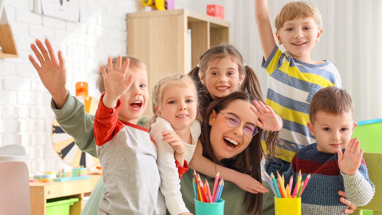Happy children and a caring teacher in a nursery classroom in Dubai.