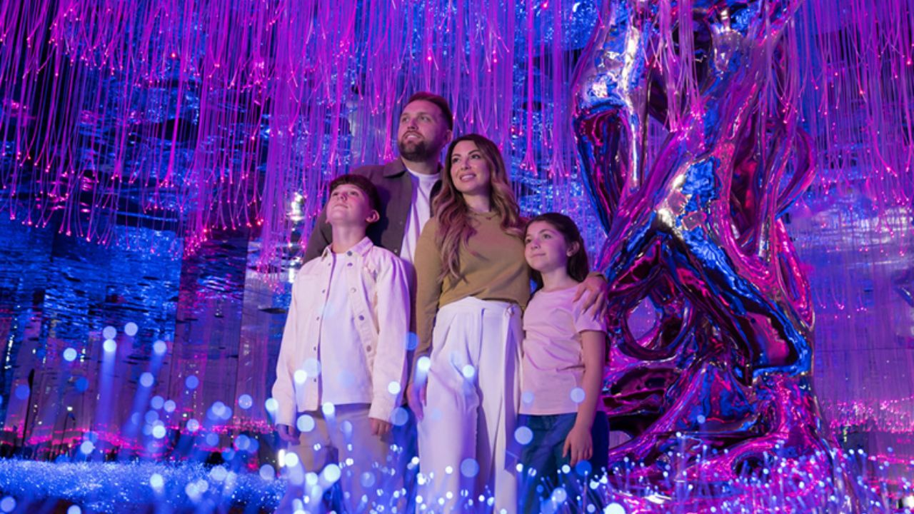 Family exploring vibrant, illuminated art in Dubai for free or at discounted rates.