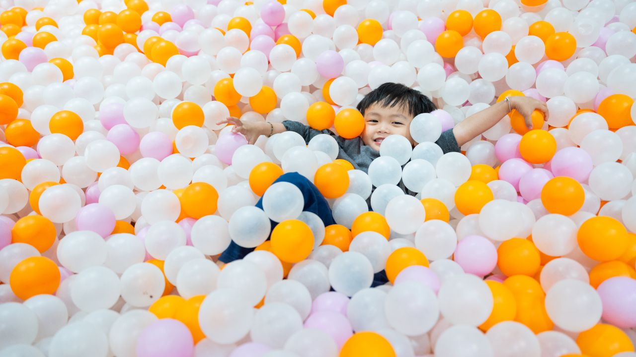 Boy Playing in Ball Pit indoor