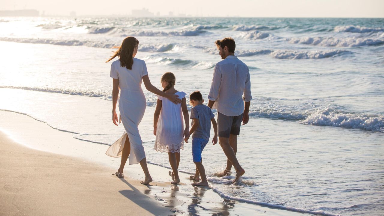 family walking by the beach