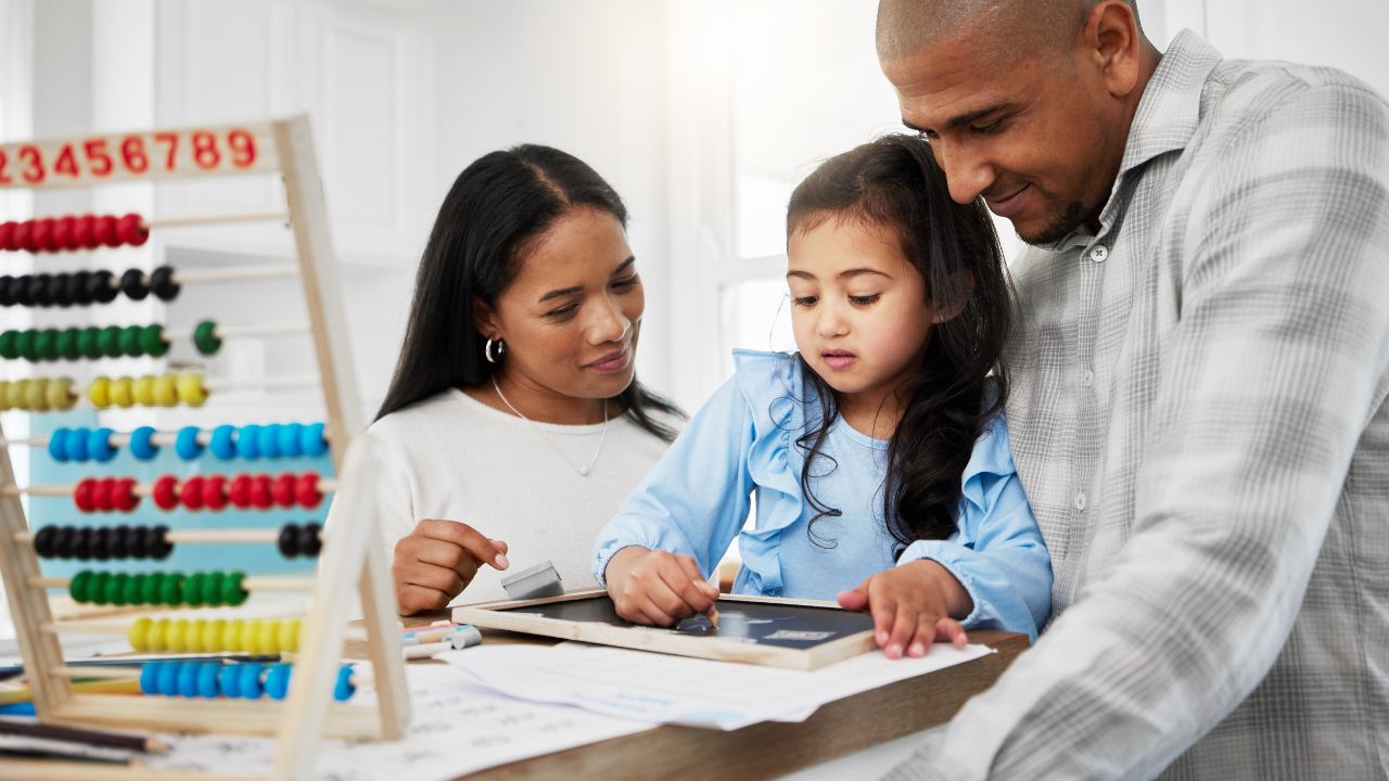 parents helping their child to answer math question