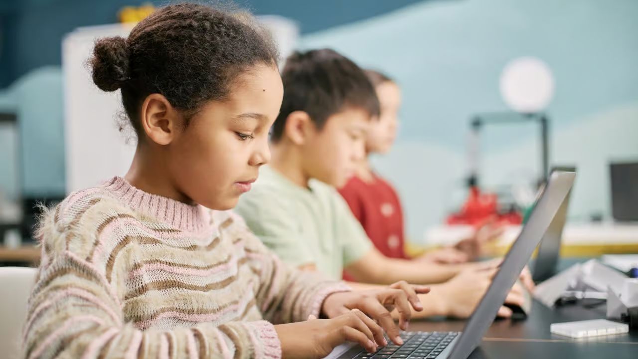 little girl focused using laptop