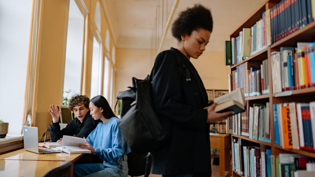 Students reading books in a calm library setting in Dubai.