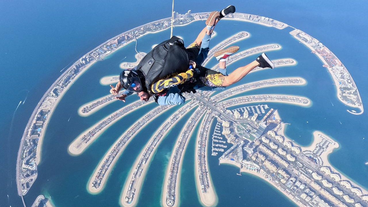 Skydiving over Dubai Palm Jumeirah man skydiving in dubai with view of palm jumeirah