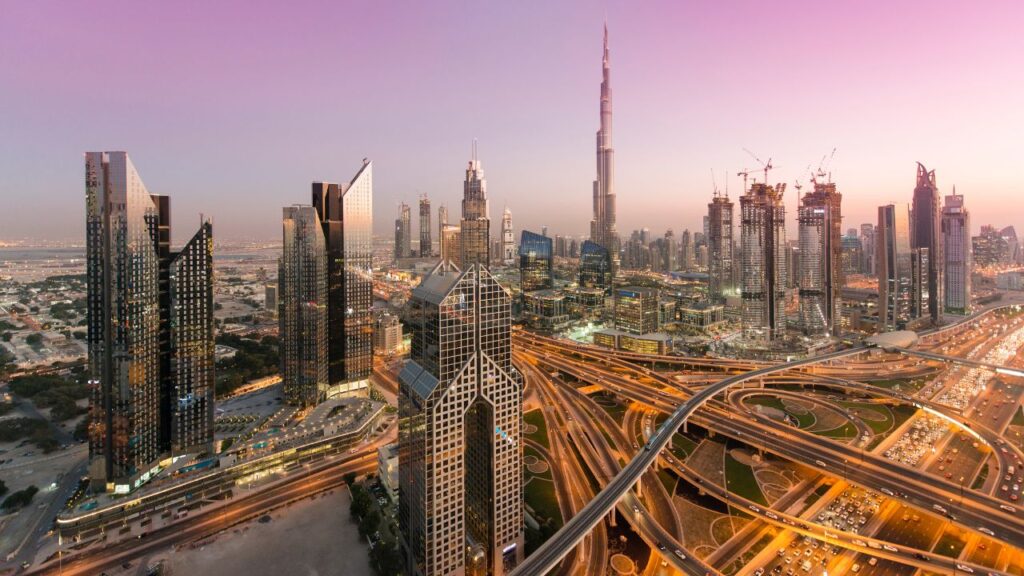 Dubai skyline featuring Burj Khalifa and contemporary skyscrapers during sunset.