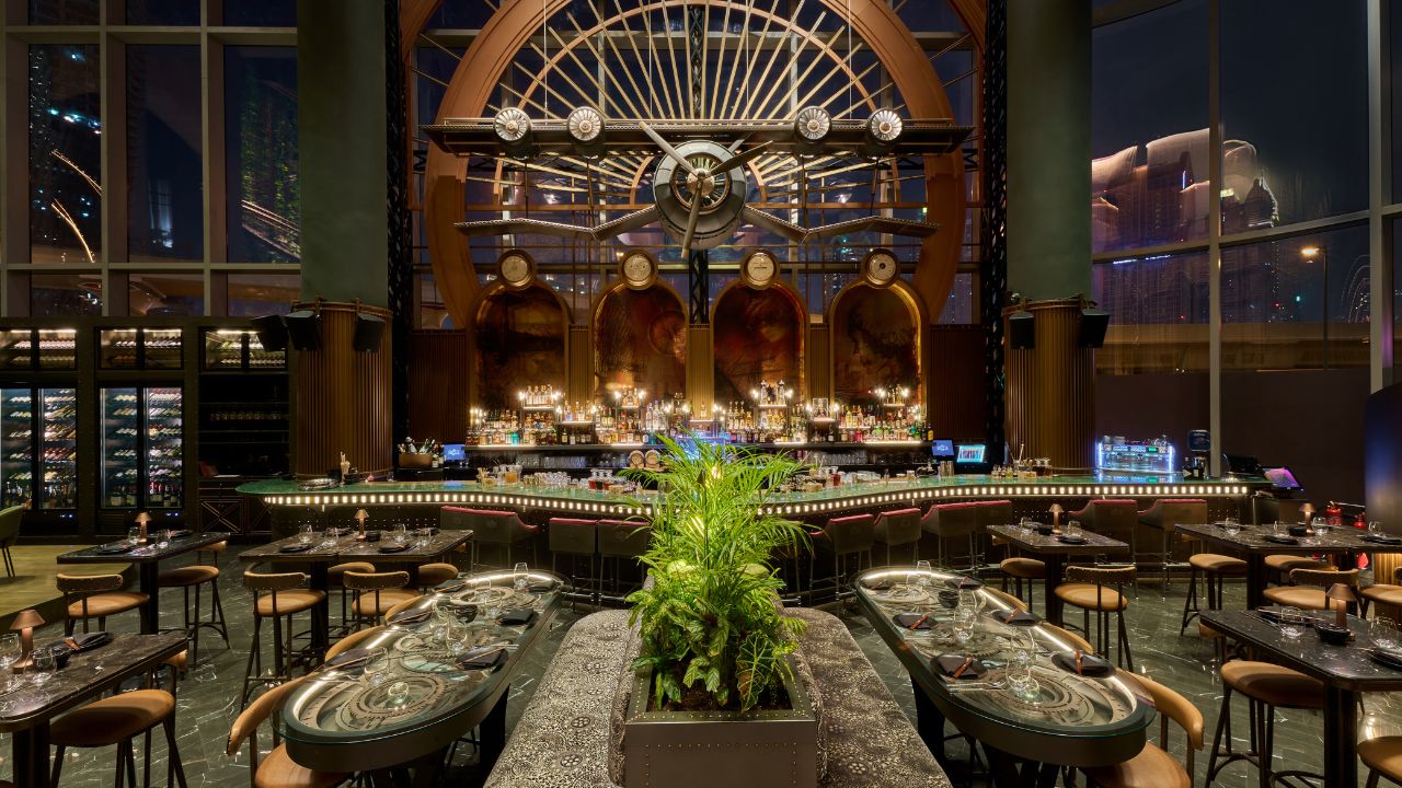 Elegant restaurant interior in Dubai with a large clock and stylish decor.