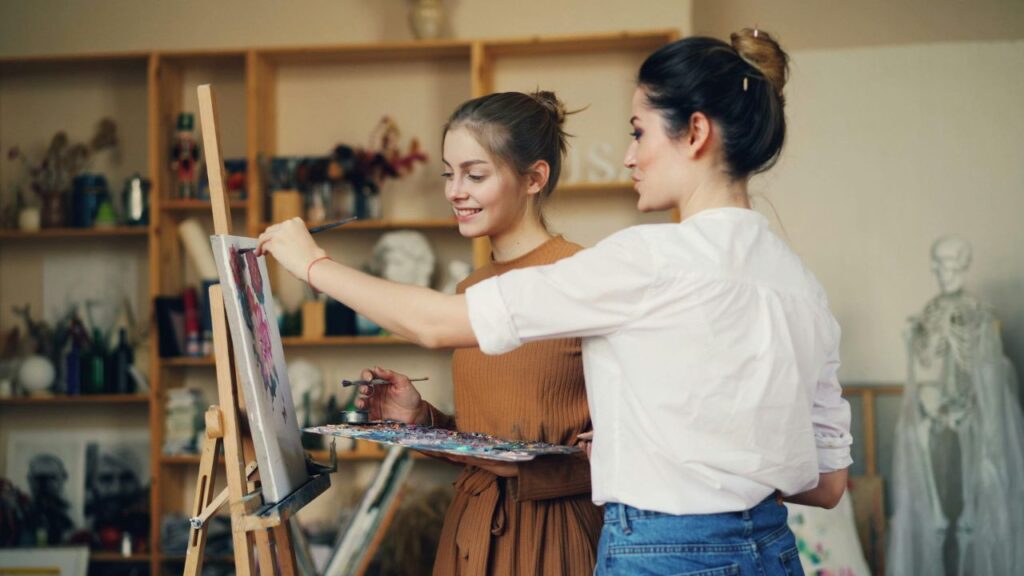 students painting in a canva in a brown room