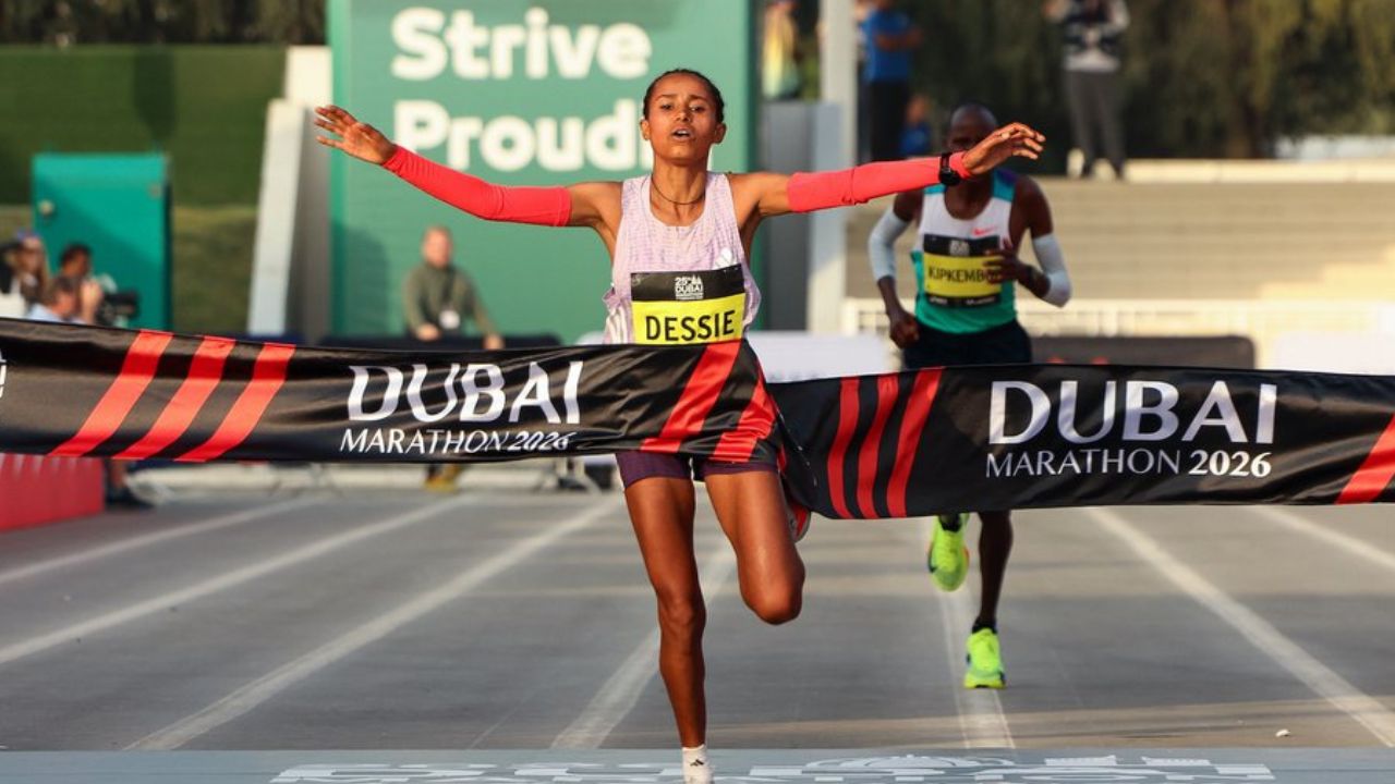 Female runner crossing the finish line at Dubai Marathon 2026.