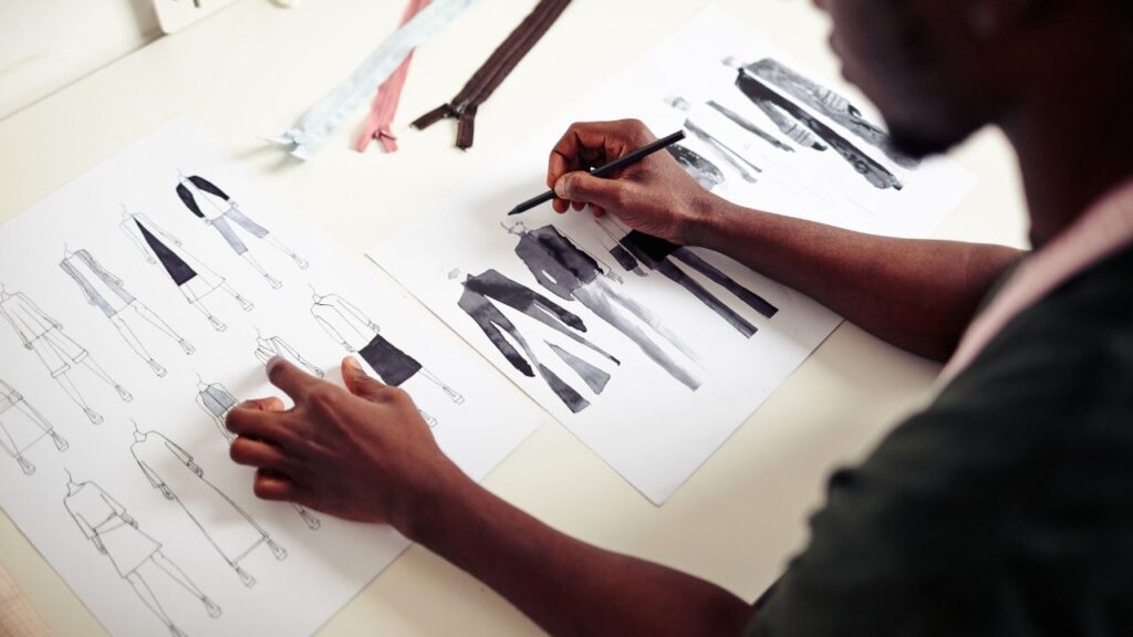 designer drawing new collection of clothes