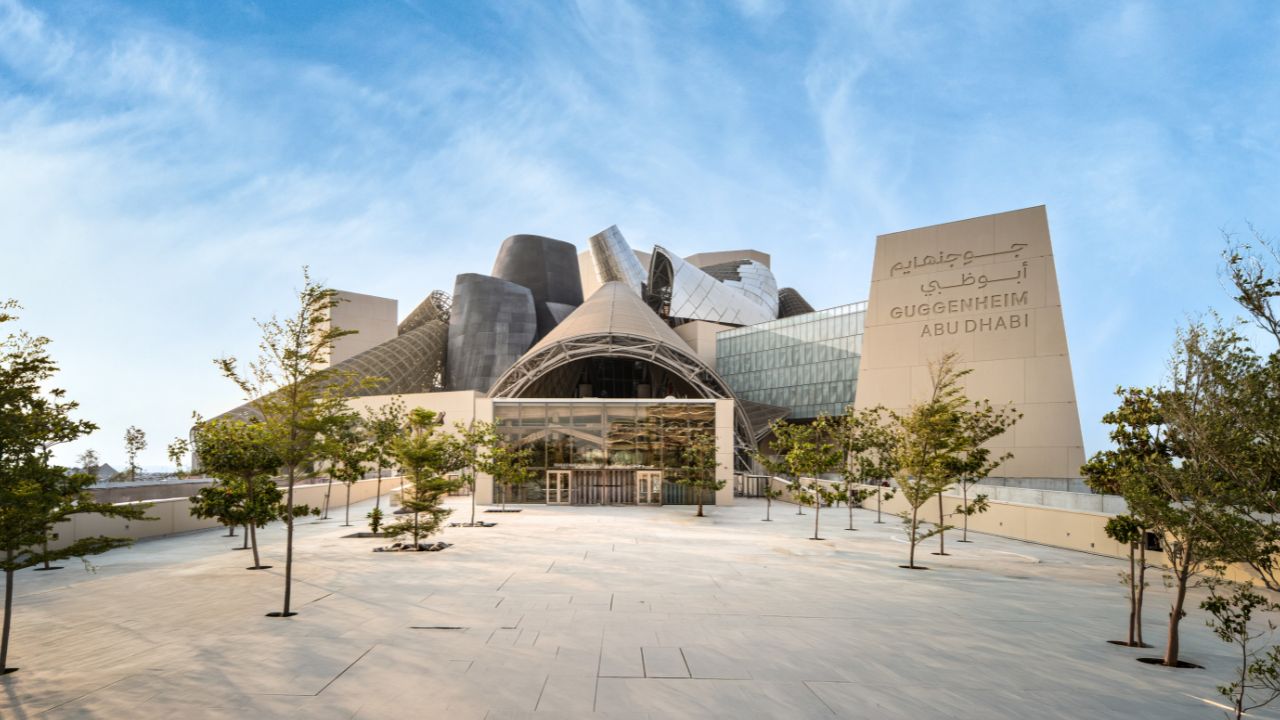 Guggenheim Abu Dhabi museum exterior with modern architecture and clear sky.