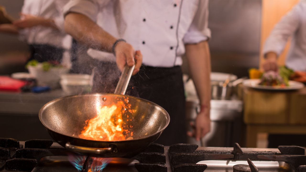chef cooking wok with flames