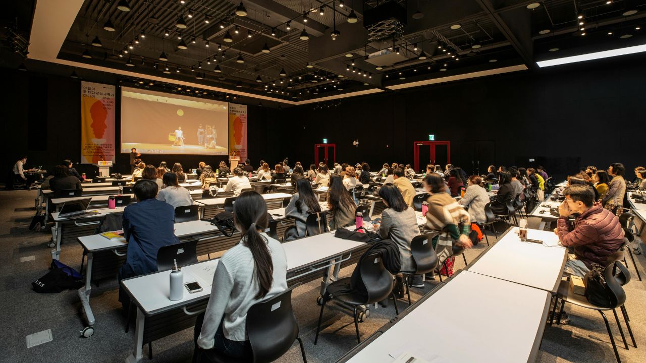 people attending and listening to a speaker during conference