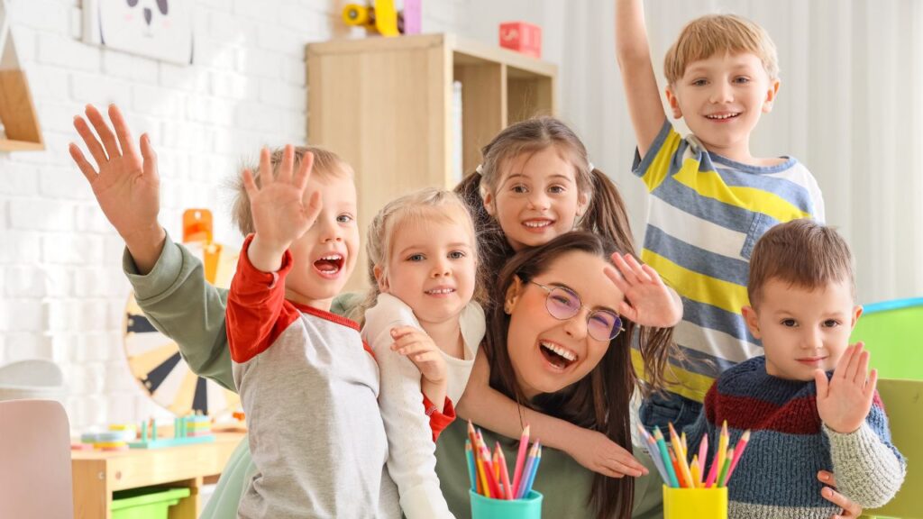 kids waving at the camera
