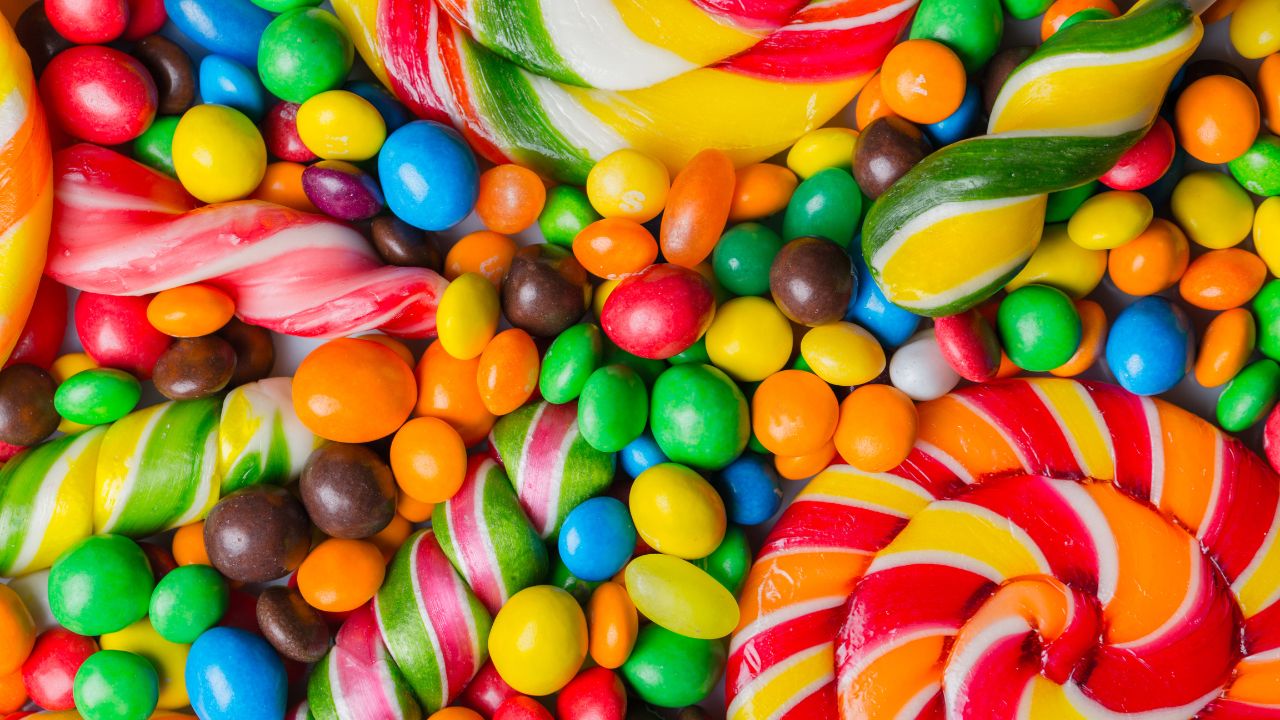 candies, lollipops and m&m scattered