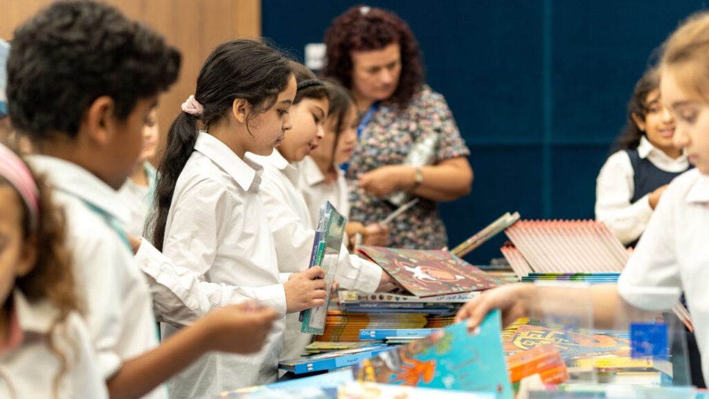 Students gather around the table with books