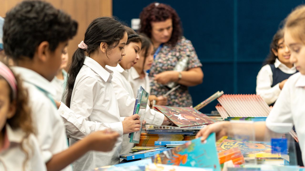 Students gather around the table with books