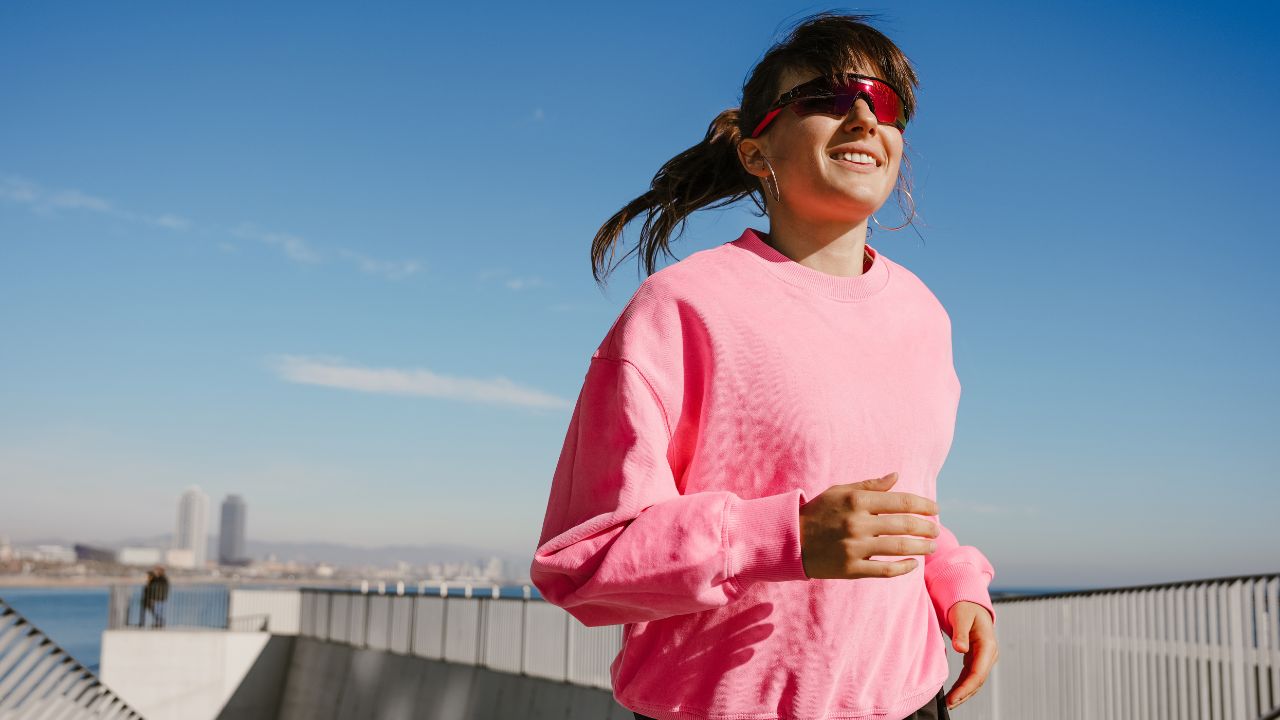 lady running pink sweater