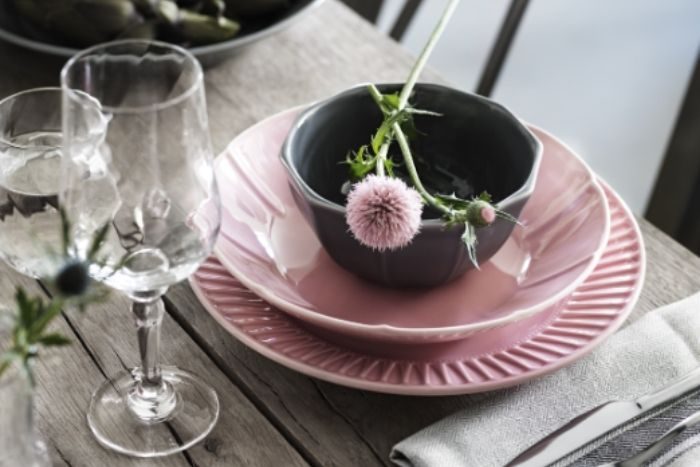 wine glass with cup and flower on table