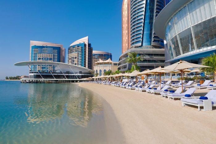 Conrad Abu Dhabi Etihad Towers pool side, with pool umbrellas, pool seats, staycaytion at Conrad Abu Dhabi Etihad Towers