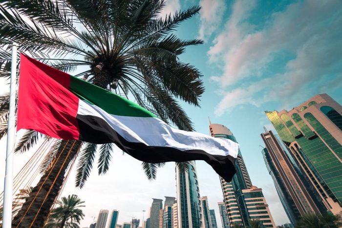 Dubai skyline with a waving UAE flag, when is the next long weekend holiday in the UAE?