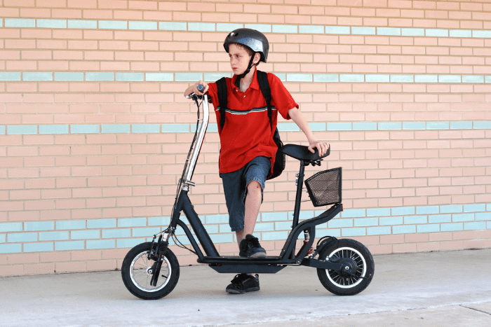 A boy with scooter in Abu dhabi bans scooters seats