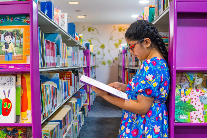 An Arabic Girl Reading A Book In A Library At Maktaba Summer Camp 2022