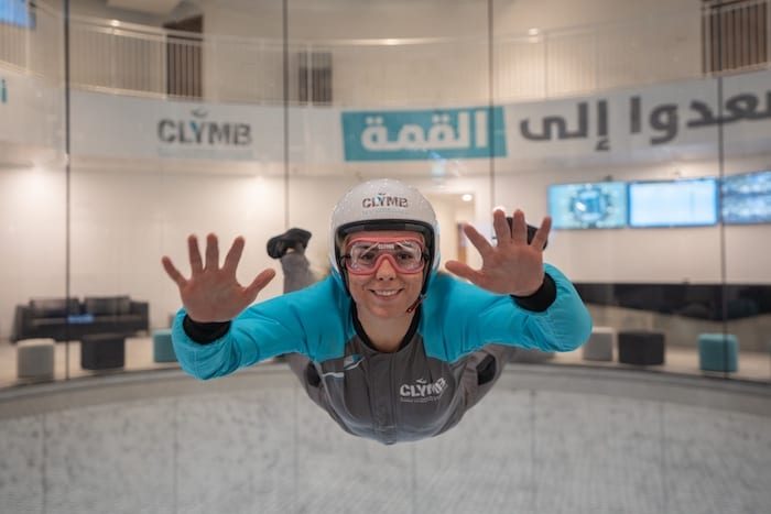 Lady skidiving indoor in clymb abu dhabi